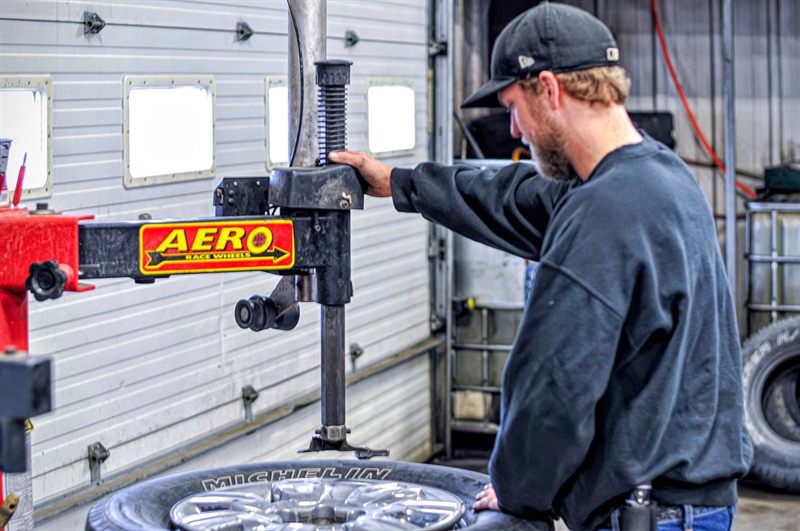 Technician mounting a new tire during tire service at Corey's Car Care Center in Fargo, ND